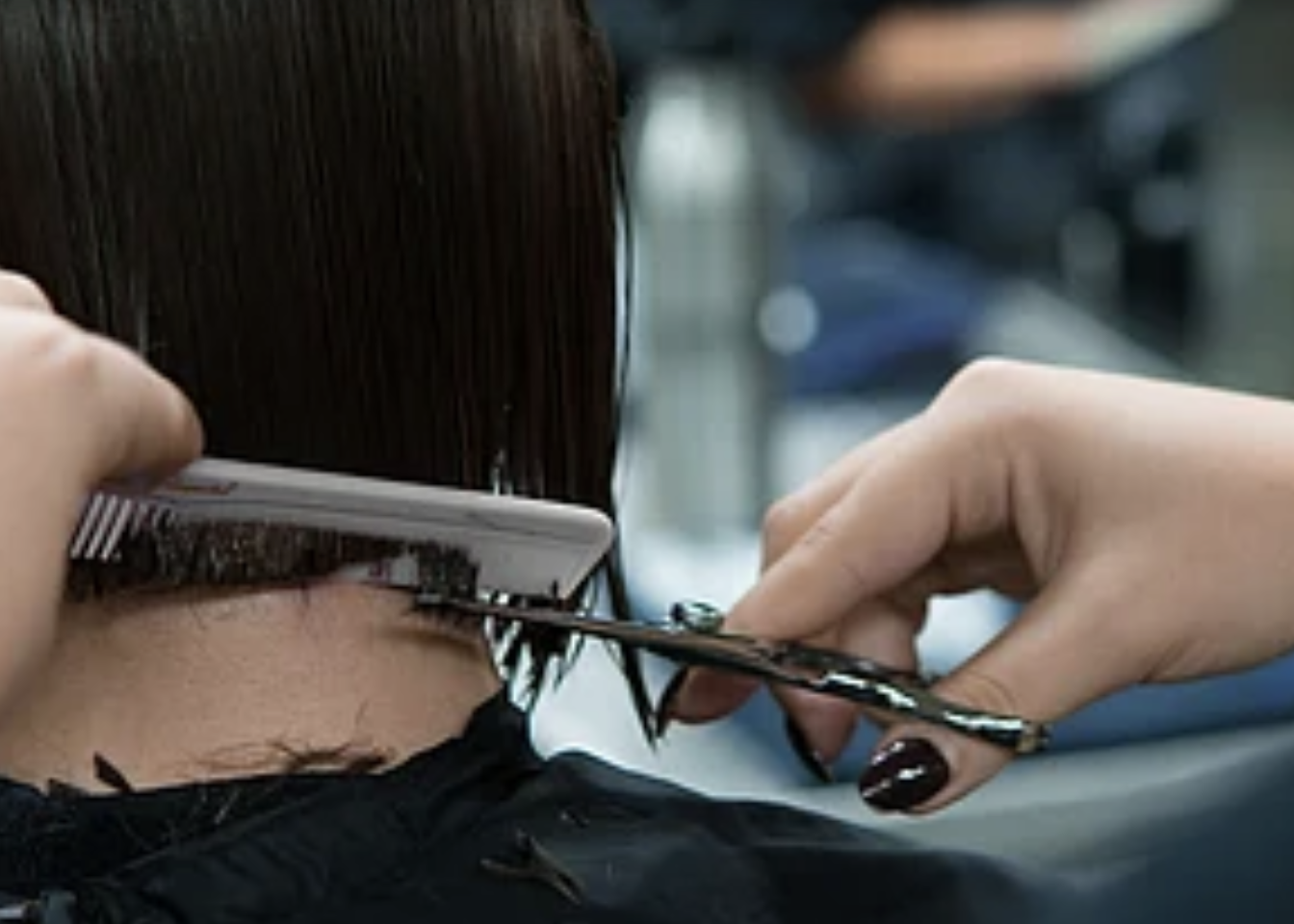 Student practicing hair cutting at O'Brien Aveda Institute
